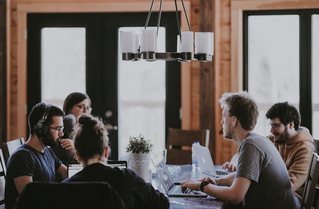 A small B2B team reviewing pipeline metrics together at a workspace